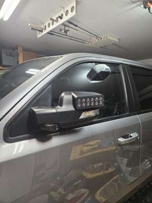 Close-up of a RAM TRX in a garage with LED Off-Road Side Mirror Ditch Lights installed.