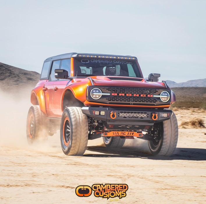 Cambered Customs Ford Bronco riding through the desert, equipped with LED Off-Road Side Mirrors.