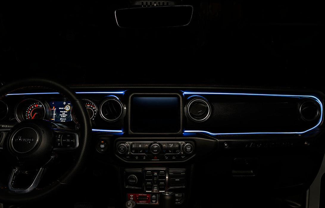The dashboard of a Jeep with ColorSHIFT Fiber Optic LED Interior Kit installed, glowing white.
