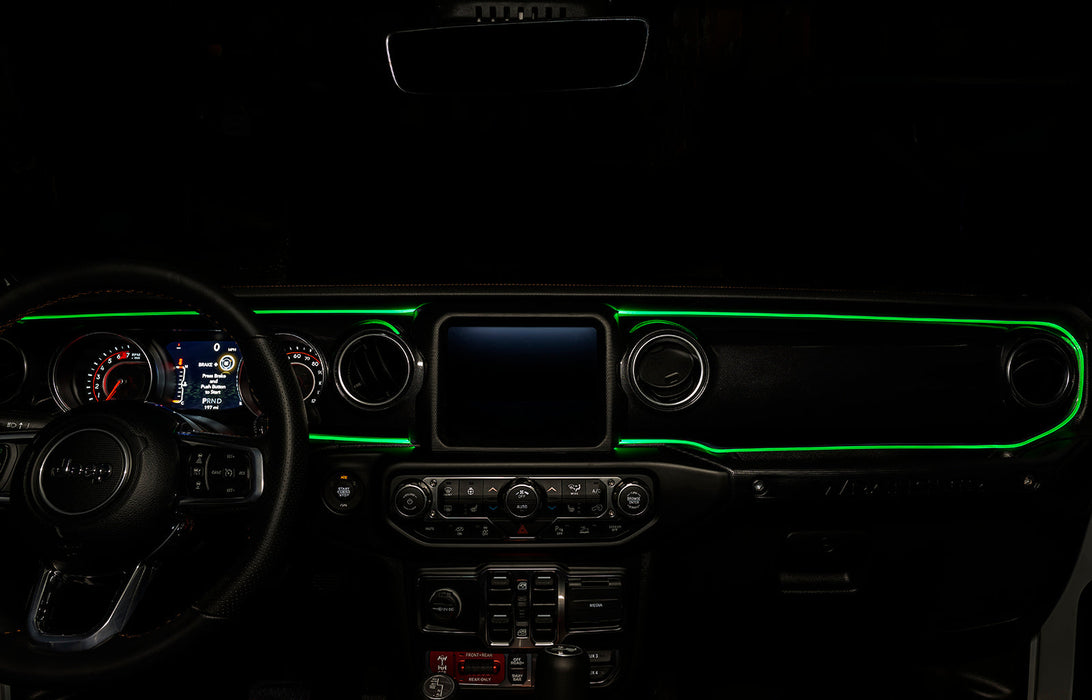 The dashboard of a Jeep with ColorSHIFT Fiber Optic LED Interior Kit installed, glowing green.