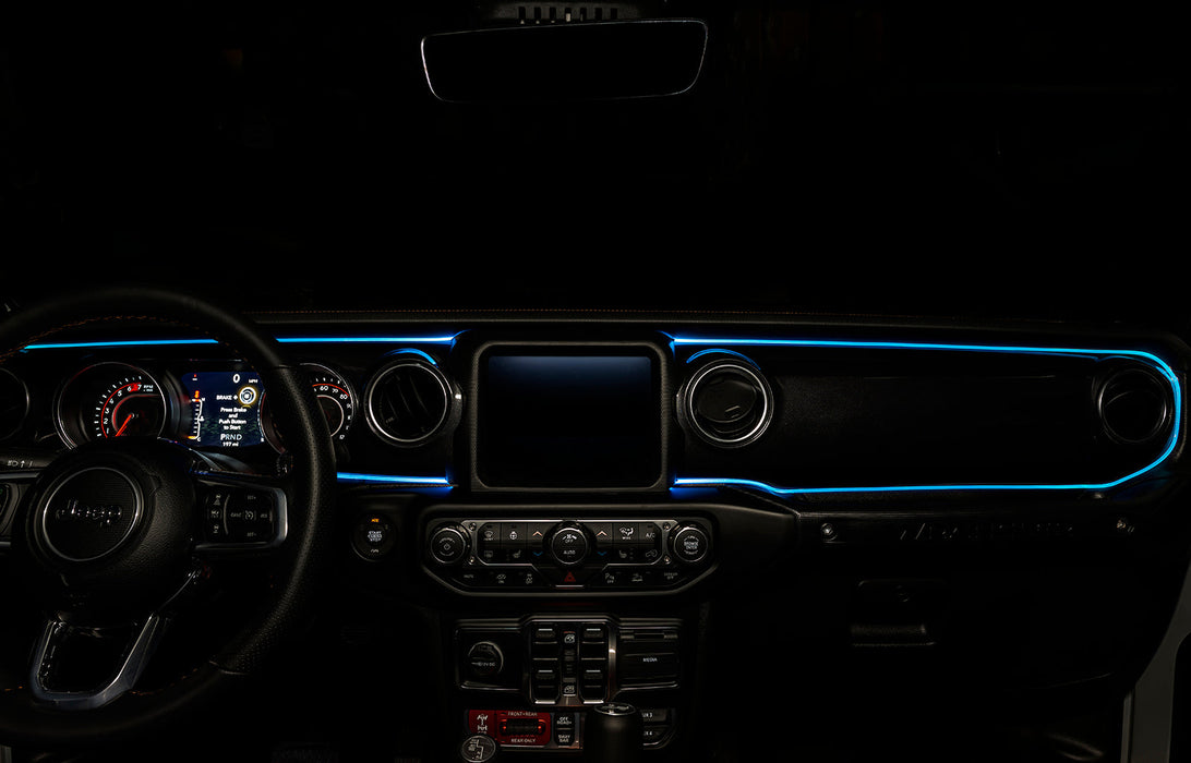 The dashboard of a Jeep with ColorSHIFT Fiber Optic LED Interior Kit installed, glowing cyan.