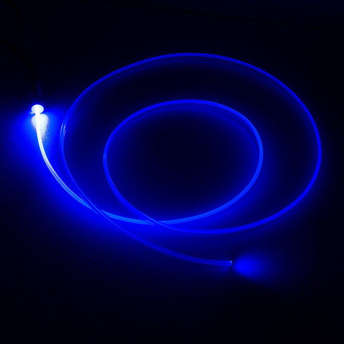 A fiber optic cable attached to a light head, glowing blue.