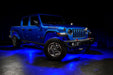 Three quarters view of a blue Jeep Gladiator JT with rock lights set to blue.