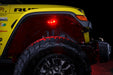 Close up on the front wheel well of a yellow jeep, with rock lights set to red LED.