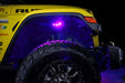 Close up on the front wheel well of a yellow jeep, with rock lights set to purple LED.