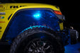 Close up on the front wheel well of a yellow jeep, with rock lights set to cyan LED.