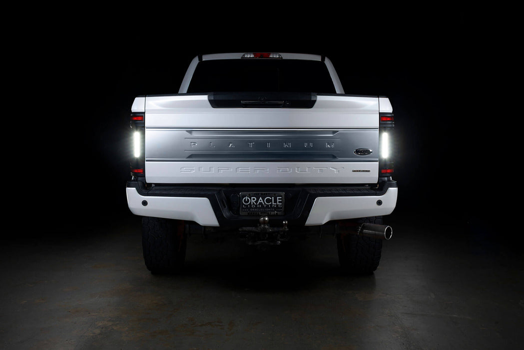 Straight rear view of a white Ford Superduty with Flush Mount Tail Lights installed and reverse lights on.