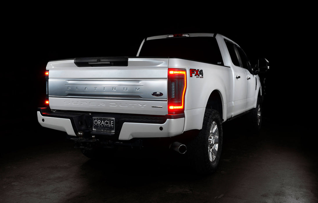 Rear three quarters view of a white Ford Superduty with Flush Mount Tail Lights installed, and brake lights on.
