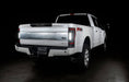 Rear three quarters view of a white Ford Superduty, with Flush Mount Tail Lights installed, and reverse lights on.