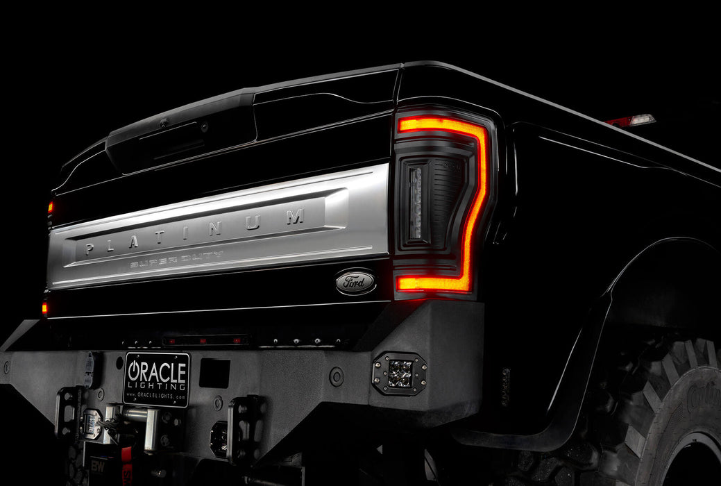 Close up on the rear end of a black Ford Superduty, with Flush Mount Tail Lights installed, with DRLs on.