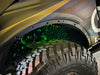 Close-up of fiber optic wheel liner kit installed on bronco with green LED lighting.