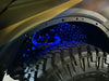 Close-up of fiber optic wheel liner kit installed on bronco with blue LED lighting.
