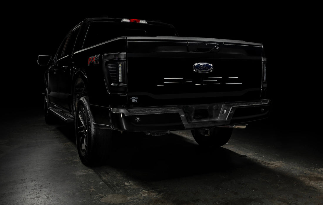 Rear three quarters view of black Ford F-150 with Tinted Flush Style LED Tail Lights installed