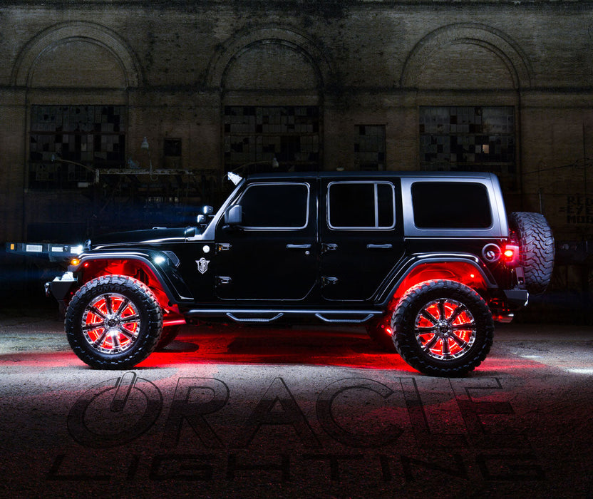 Side profile of a black Jeep with multiple ORACLE Lighting products installed, the focus being the red LED wheel rings.