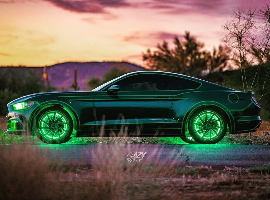 Side view of a Ford Mustang with green DRLs and green LED wheel rings.