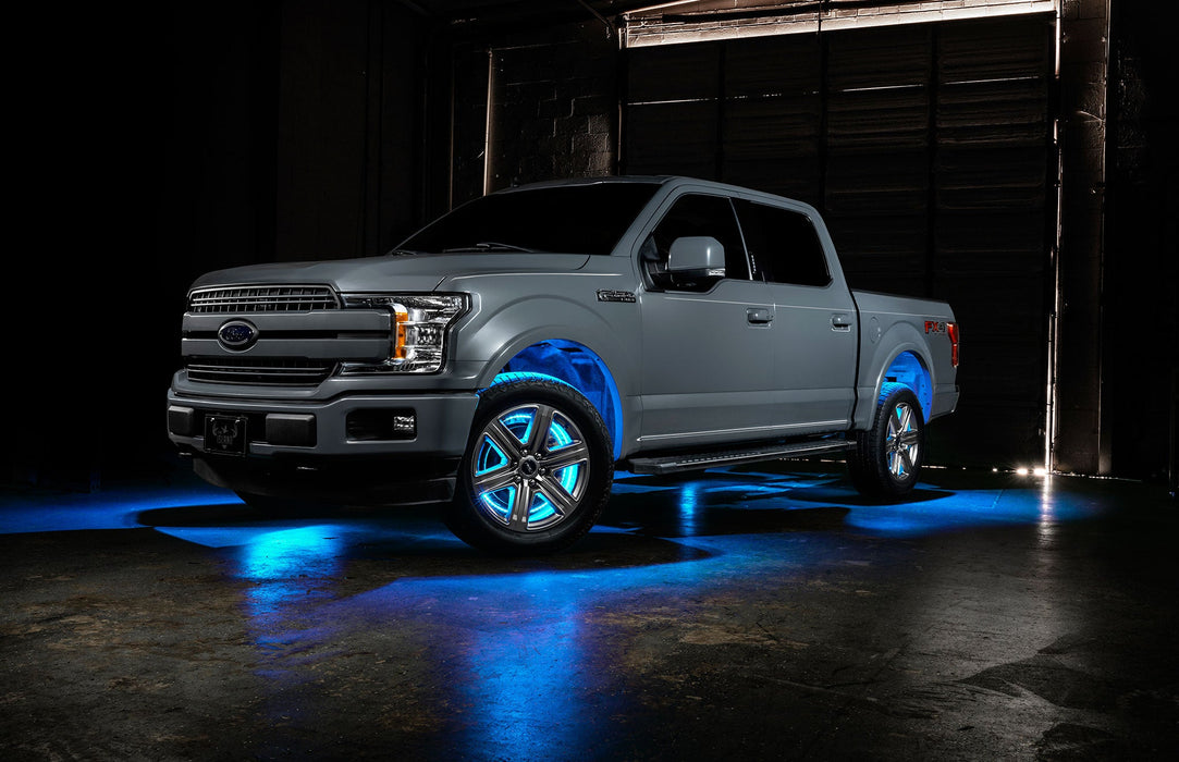 Grey Ford F-150 with cyan wheel rings and rock lights.