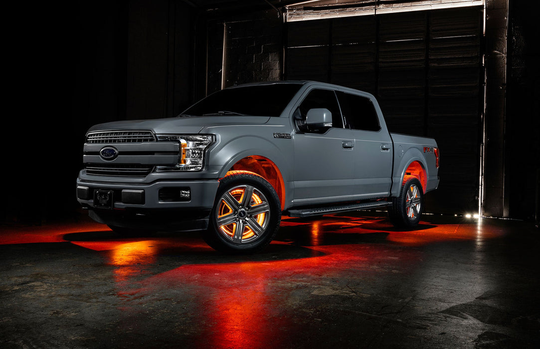 Grey Ford F-150 with amber wheel rings and rock lights.