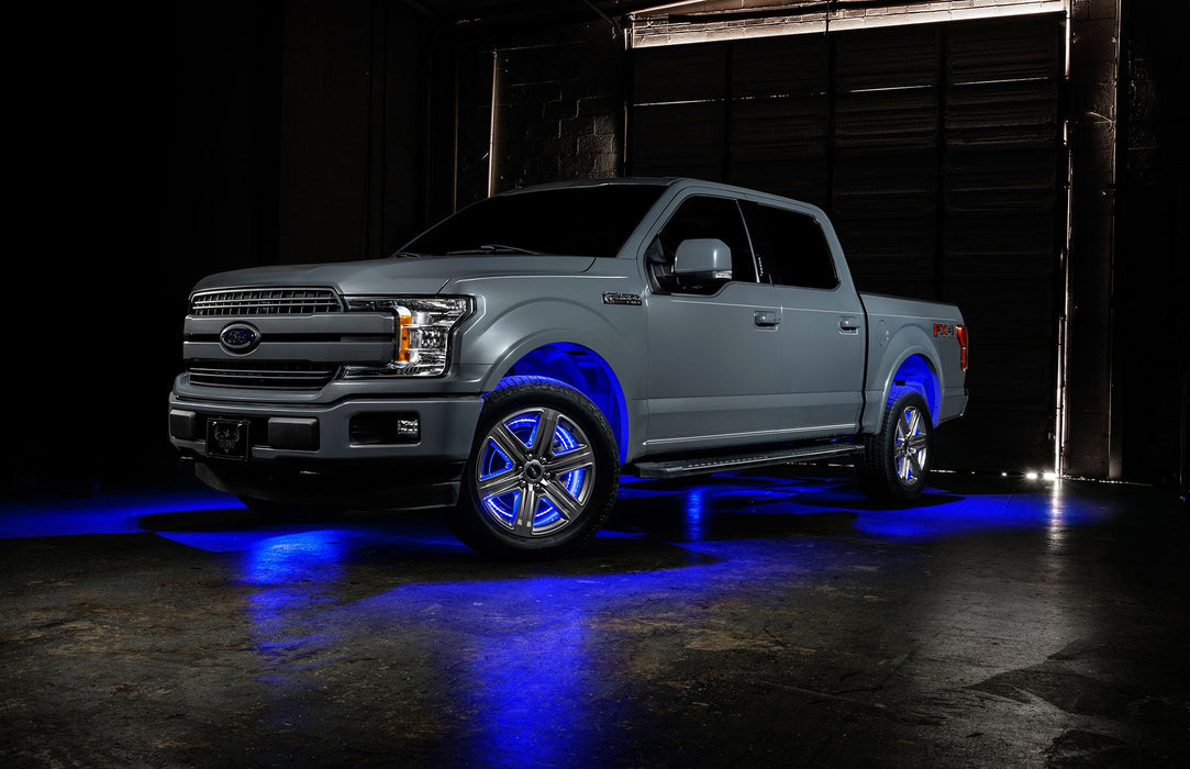 Grey Ford F-150 with blue wheel rings and rock lights.