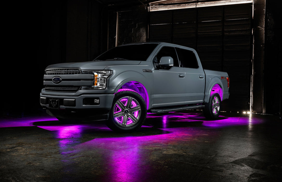 Grey Ford F-150 with pink wheel rings and rock lights.