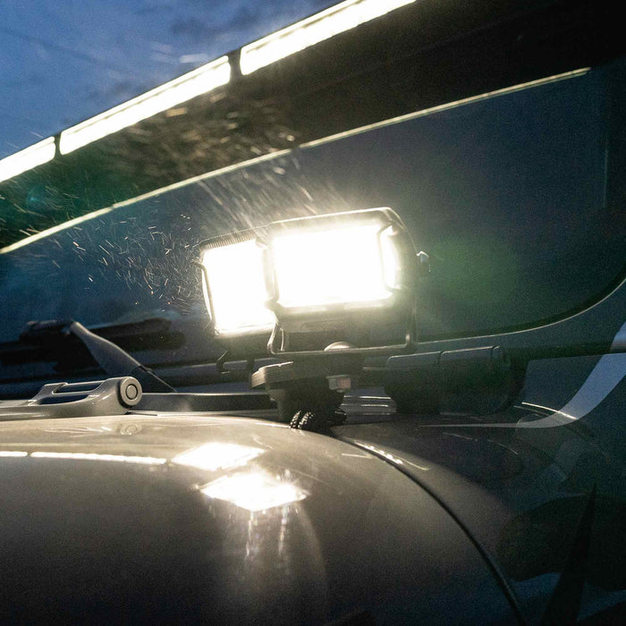 Close-up view of VEGA Series 2 and VEGA Series 4 installed on the hood of a Jeep Gladiator JT. The light pods are turned on and shining brightly.