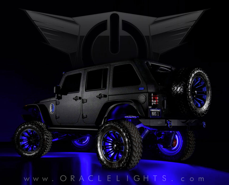 A rear three quarters view of a black Jeep with blue LED wheel rings installed.