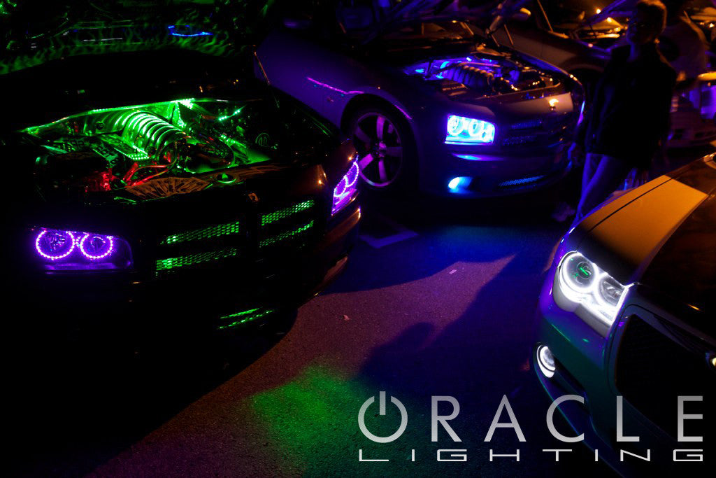 Cars lined up showing engine bay glowing with LED lights.