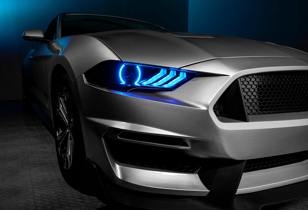 Close-up of Ford Mustang headlight with cyan LEDs.