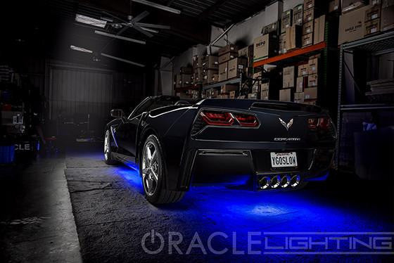 Corvette in a garage with blue LED underbody kit.