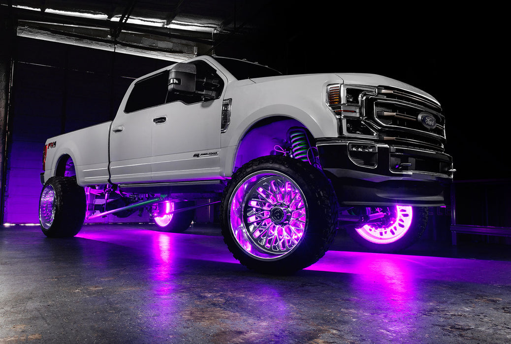 White Ford Superduty with pink LED wheel rings.