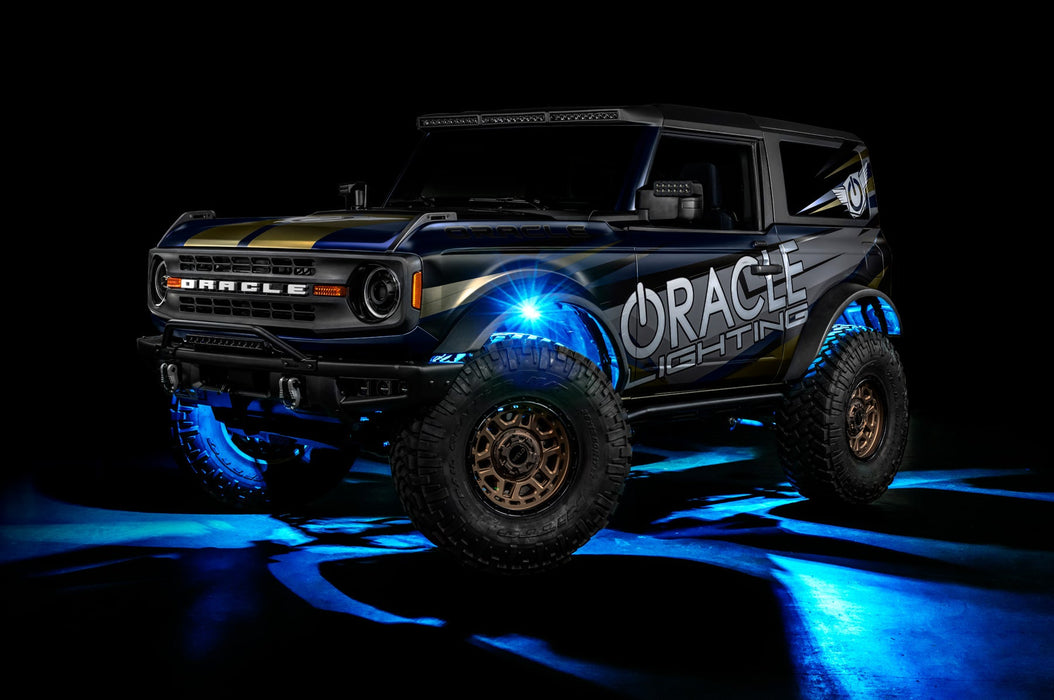 Three quarters view of a Ford Bronco with LED rock lights set to cyan.