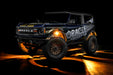 Three quarters view of a Ford Bronco with LED rock lights set to amber.