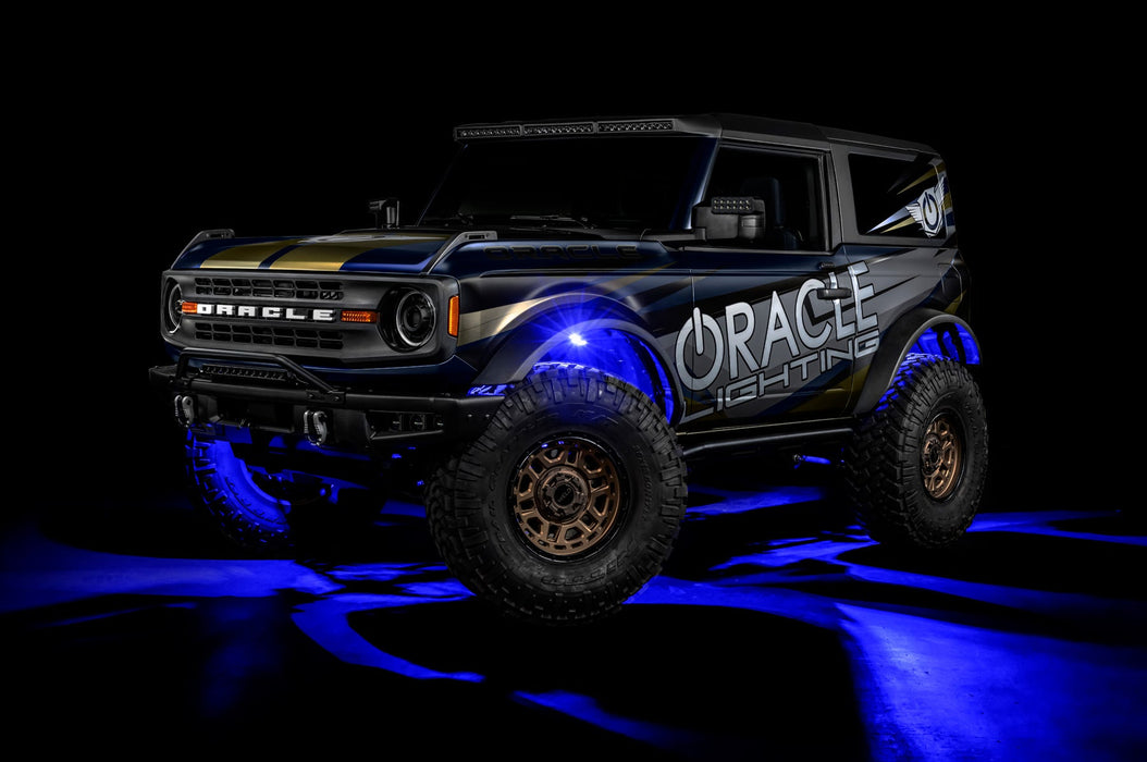 Three quarters view of a Ford Bronco with LED rock lights set to blue.