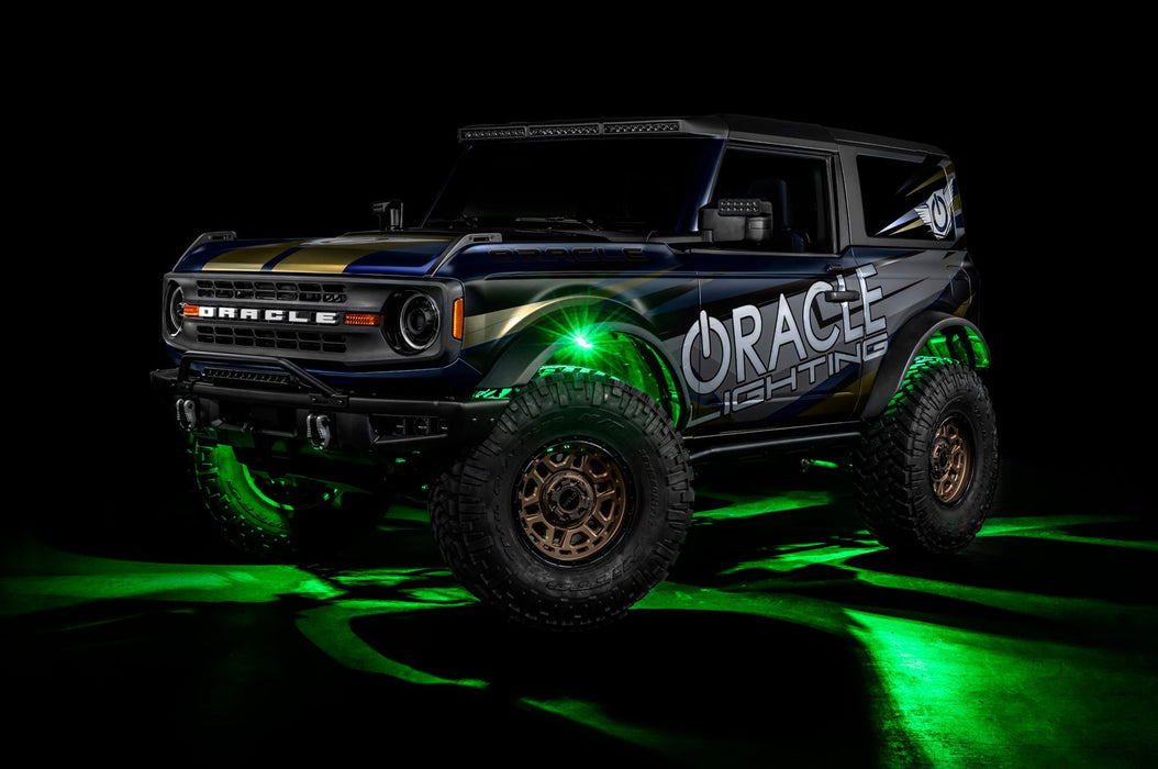 Three quarters view of a Ford Bronco with LED rock lights set to green.
