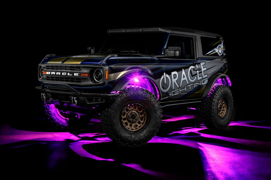 Three quarters view of a Ford Bronco with LED rock lights set to pink.