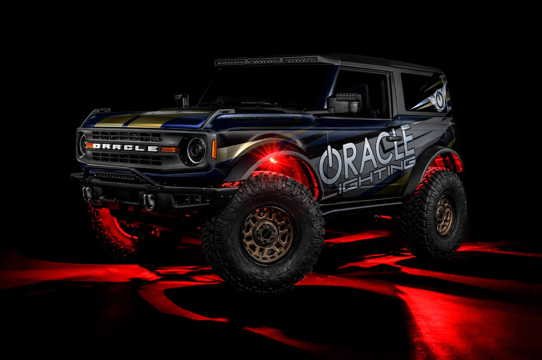 Three quarters view of a Ford Bronco with LED rock lights set to red.