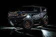 Three quarters view of a Ford Bronco with LED rock lights set to white.