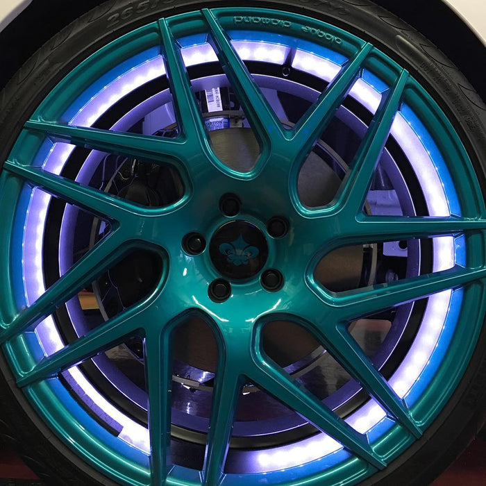 Extreme close-up of a wheel with LED illuminated wheel rings installed.