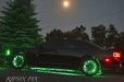 Low quality photograph of a black Dodge Charger with green LED wheel rings installed.