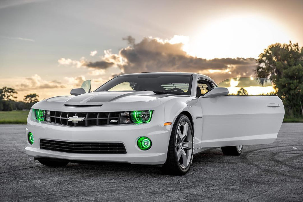 Three quarters view of a Chevrolet Camaro with green LED headlight and fog light halo rings installed.