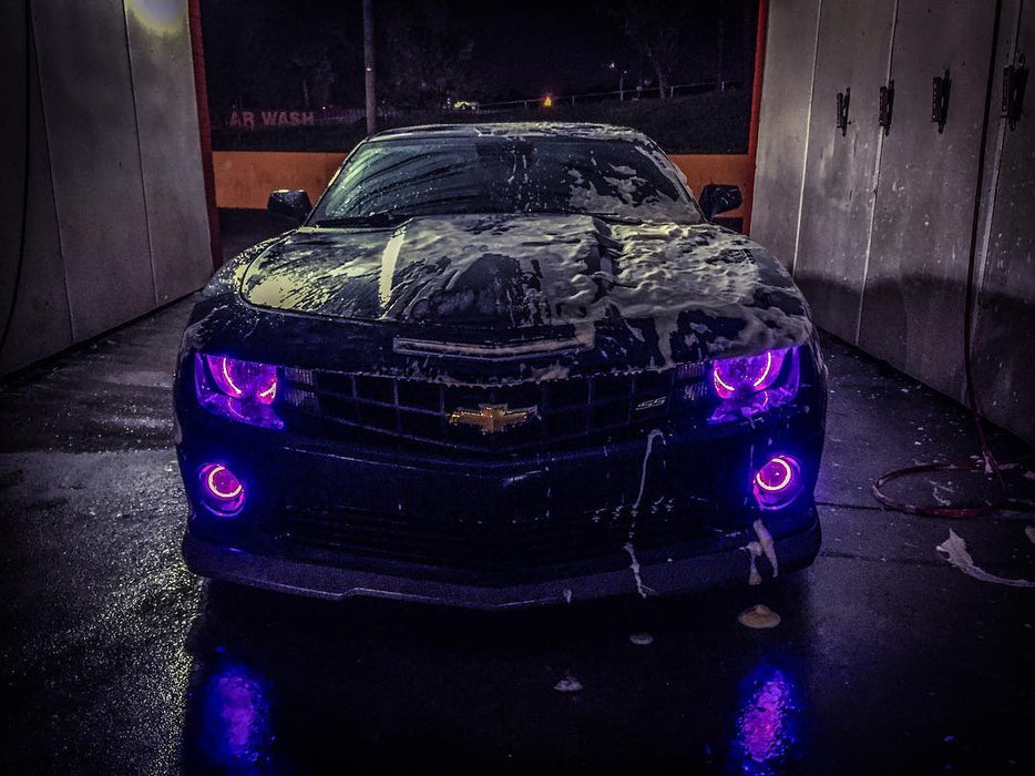 Chevrolet Camaro going through a car wash with purple LED headlight and fog light halo rings installed.