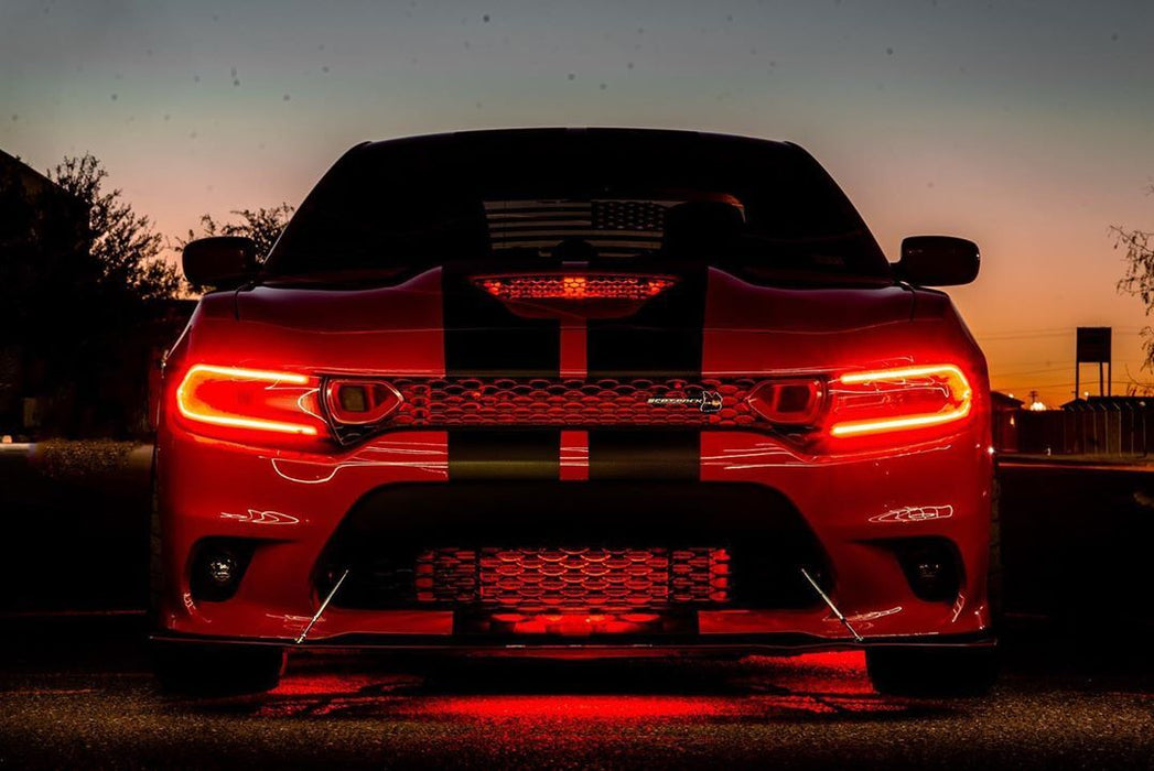 Front end of a red Dodge Charger with red headlight DRLs.