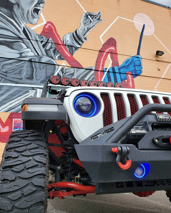 Front end of a Jeep with ColorSHIFT Oculus Headlights installed, and blue halo rings.