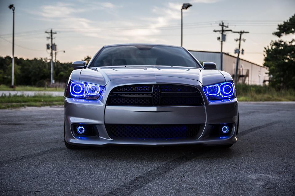 Front view of a silver Dodge Charger with blue LED headlight and fog light halo rings installed.