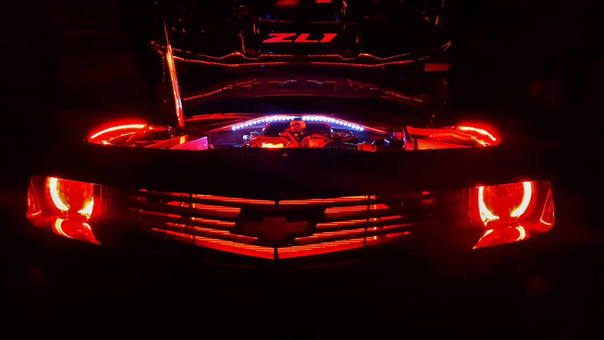 Front end of a Chevrolet Camaro with red LED engine bay lighting.