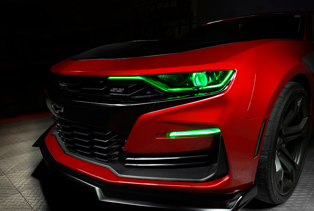Front end of a red Chevrolet Camaro with green headlight DRLs.