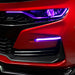 Close-up on a red Chevrolet Camaro with purple fog light DRLs.