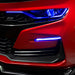 Close-up on a red Chevrolet Camaro with blue fog light DRLs.