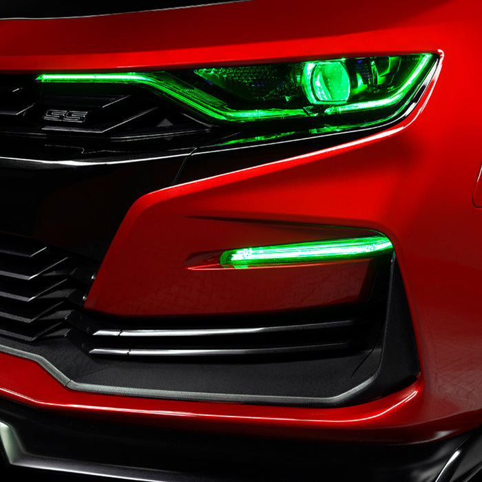 Close-up on a red Chevrolet Camaro with green fog light DRLs.