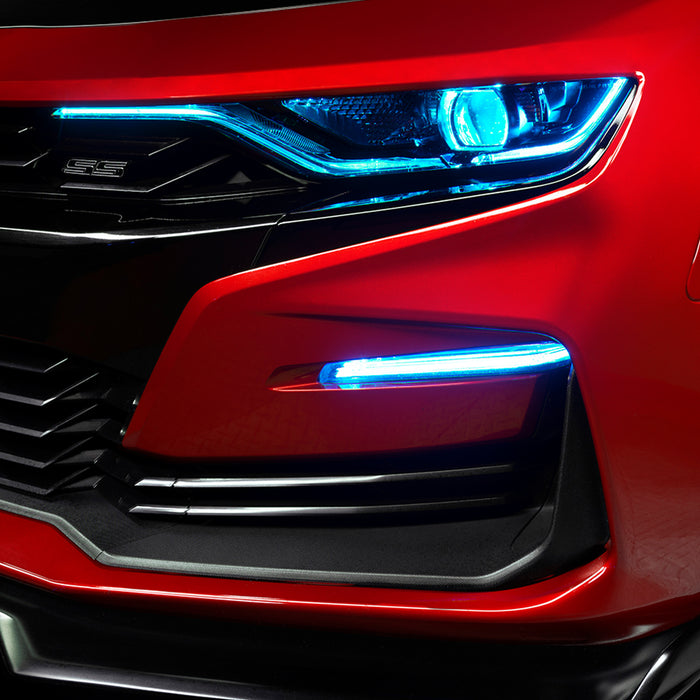 Close-up on a red Chevrolet Camaro with cyan fog light DRLs.