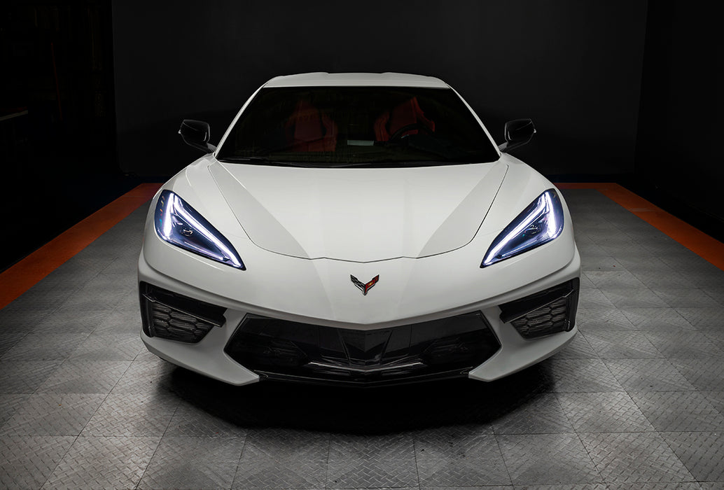 Front view of a white C8 Corvette with white headlight DRLs.